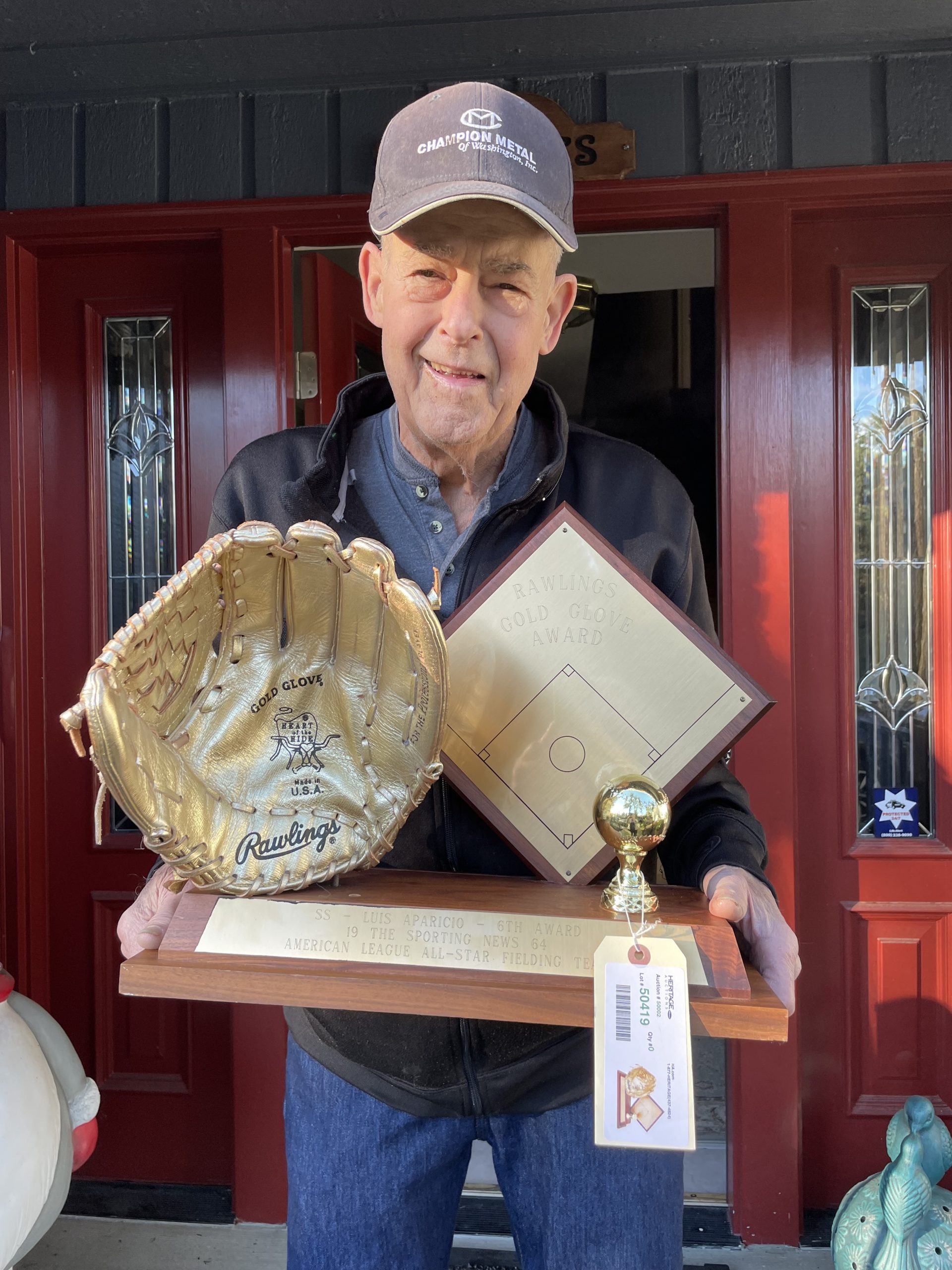John Devore holding his sports memorabilia