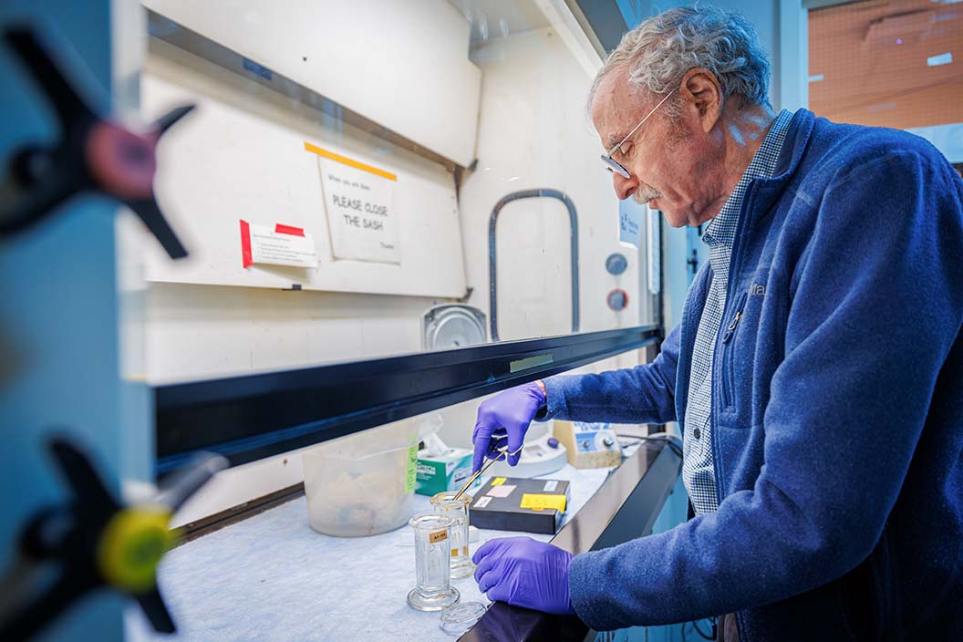 Fred Hutch microbiologist Steven Henikoff prepares paraffin-embedded slides in lab.